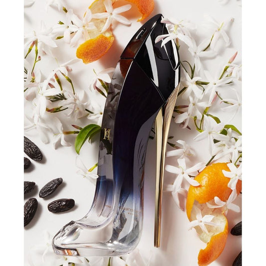 Perfume bottle shaped like a high heel with floral, orange peel, and tonka bean accents.