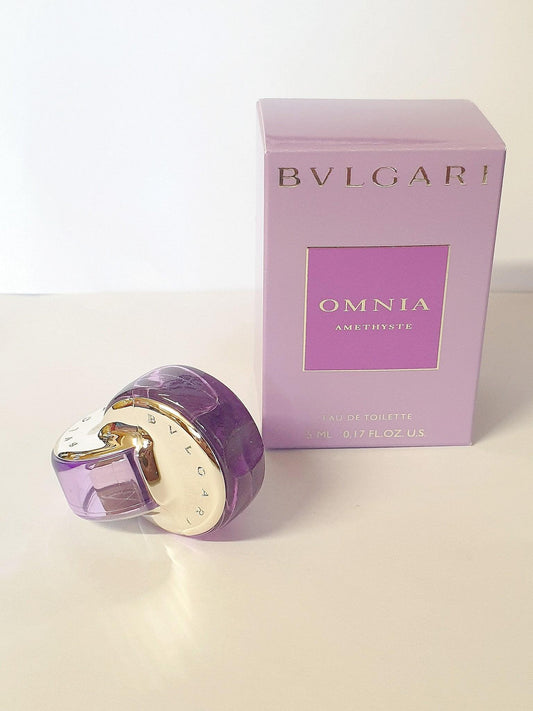 Bvlgari Omnia Amethyste Eau de Toilette 5ml bottle with purple glass and gold cap, alongside its lavender box.