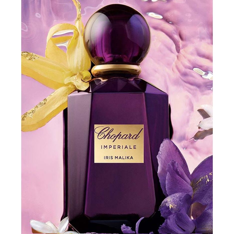 Chopard Imperiale Iris Malika purple perfume bottle with floral accents on a pink background