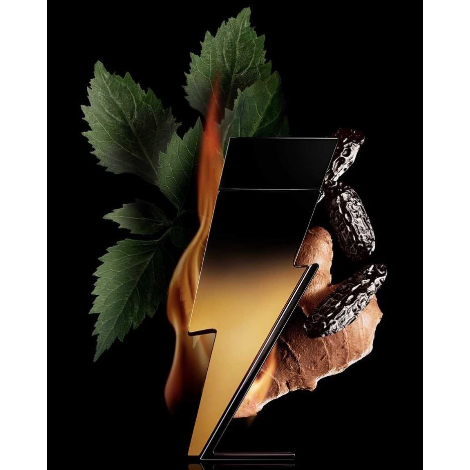 Lightning bolt shaped perfume bottle with mint leaves, fire, tonka beans, and ginger root