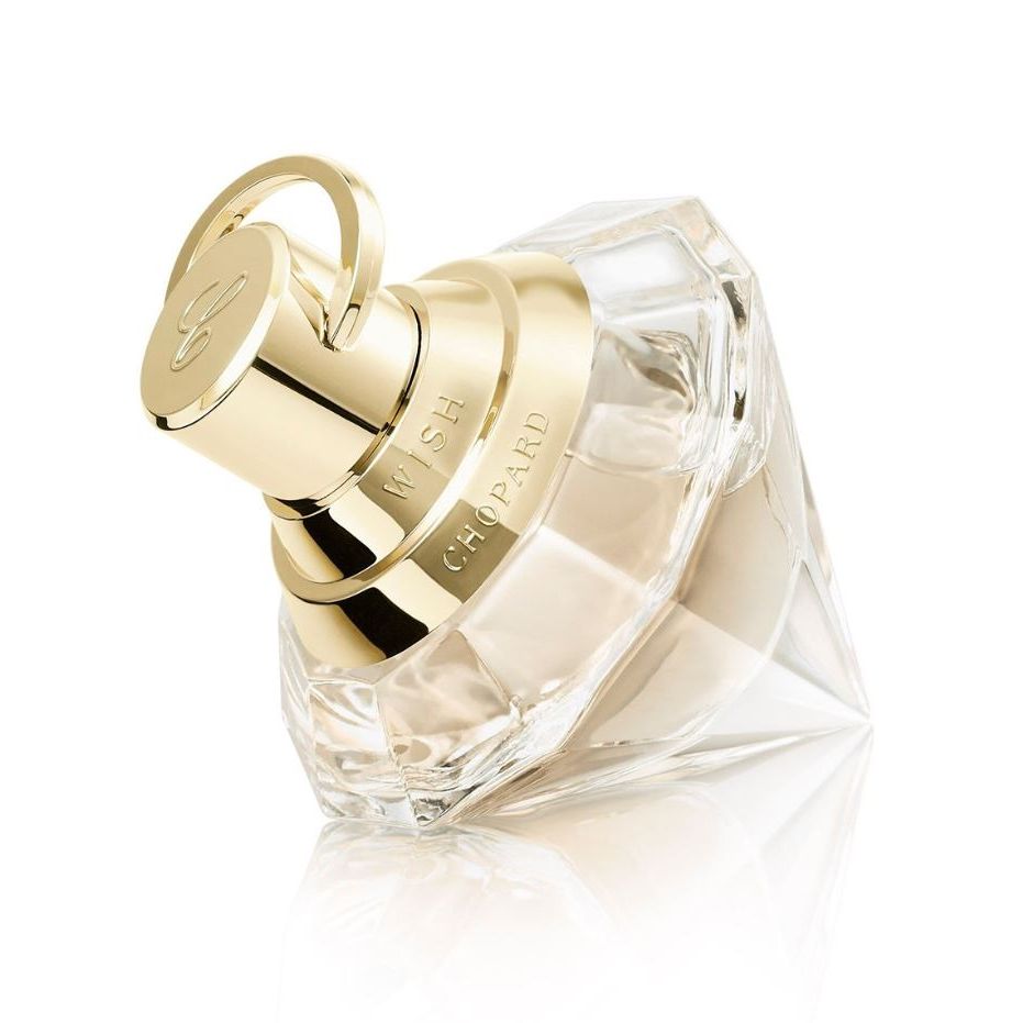 Luxury Chopard Wish perfume bottle with gold cap and faceted glass design on white background