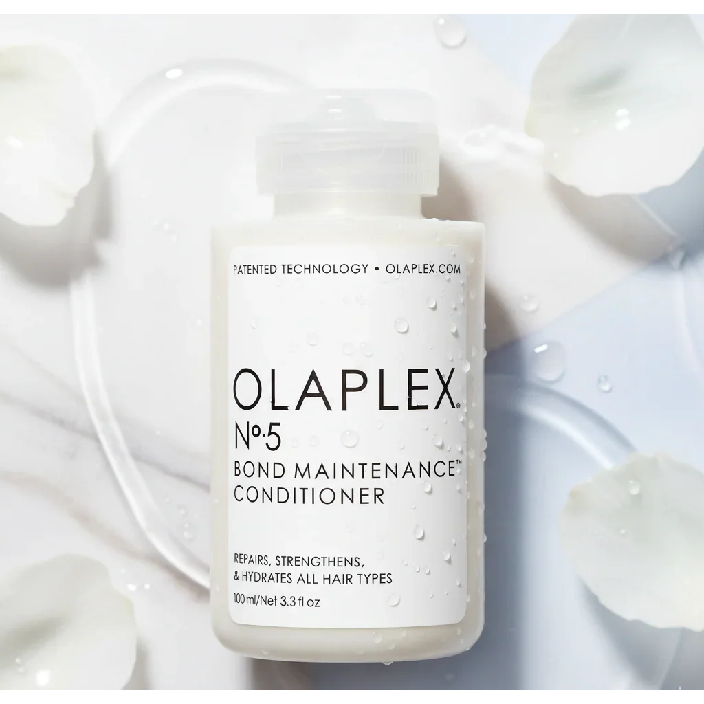 Olaplex No. 5 Bond Maintenance Conditioner bottle with water droplets and petals