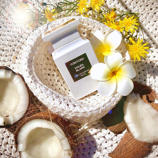 Tom Ford Soleil Blanc perfume with tropical flowers, coconut, and summer crochet setting
