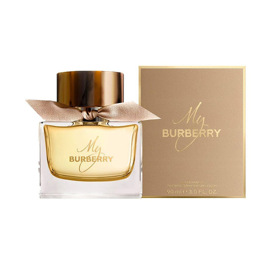 My Burberry perfume bottle with gold cap and bow beside matching gold box