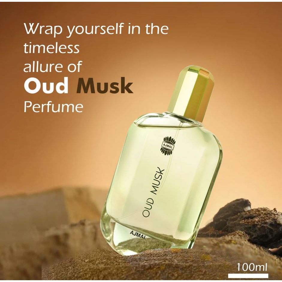 Clear glass bottle of Oud Musk perfume 100ml with gold cap, displayed on natural rocks