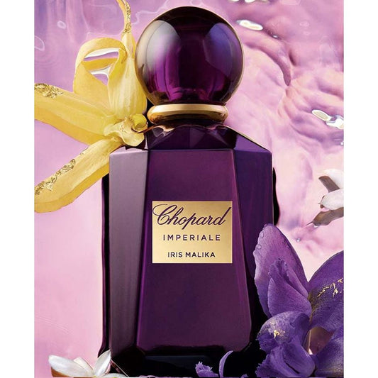 Chopard Imperiale Iris Malika purple perfume bottle with floral accents on a pink background