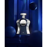 Luxury perfume bottle with silver accents displayed in a dramatic blue setting