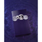 Luxury purple perfume box with ornate silver emblem, featuring Arabic script and intricate designs on a geometric background.