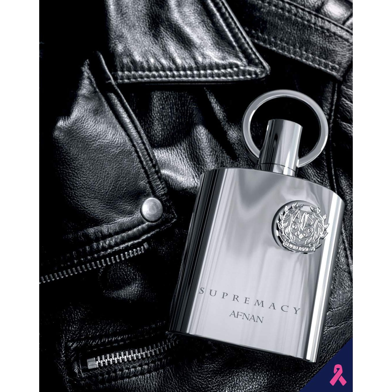 Supremacy Afnan luxury perfume bottle on black leather jacket, sleek silver design with emblem