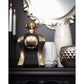 Luxury gold and black perfume bottle on elegant vanity with candles and decorative vases