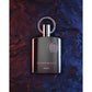 Supremacy AFNAN luxury perfume bottle with sleek design and metallic accents on textured background