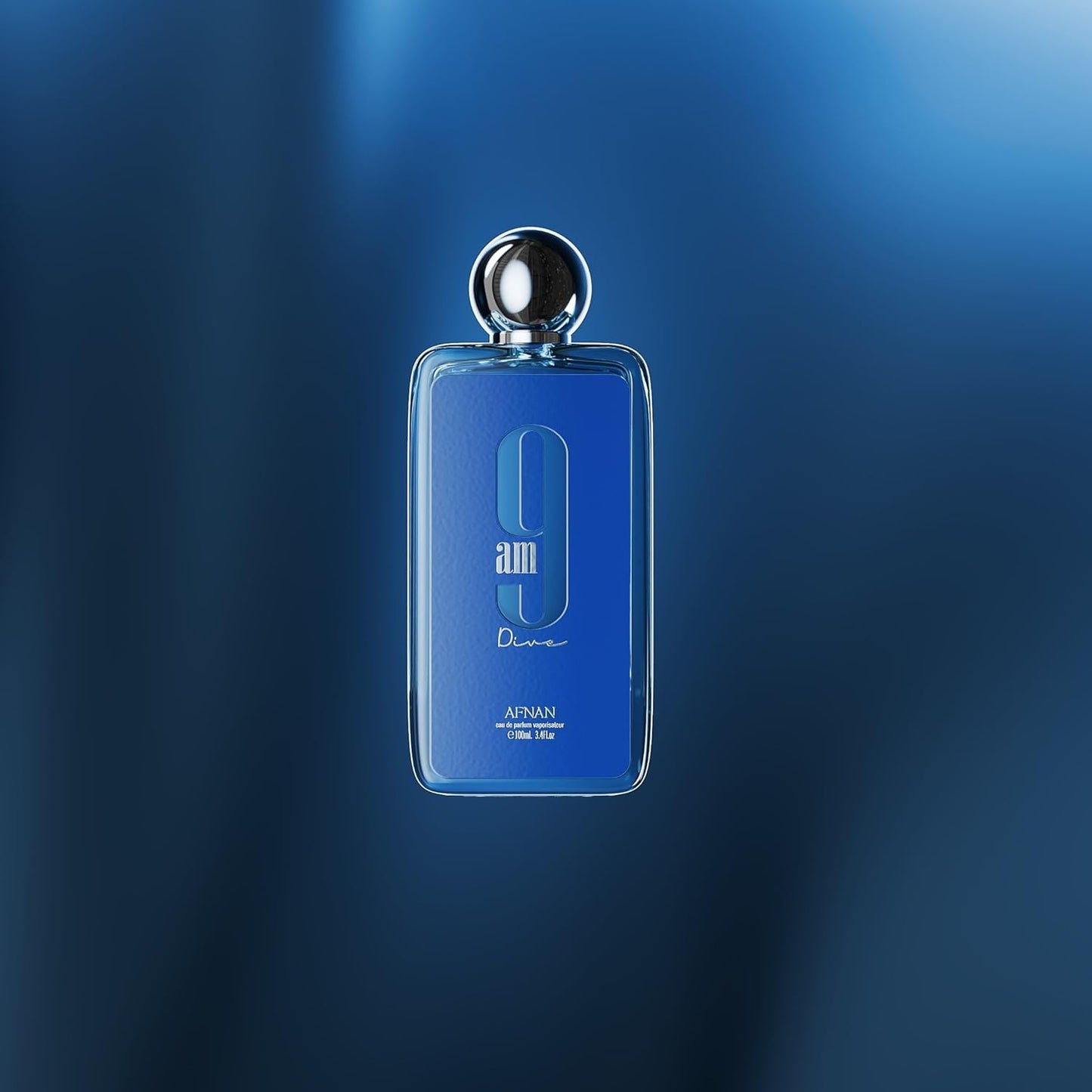 Afnan 9am Dive blue perfume bottle with silver cap on a blue gradient background
