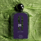 Afnan 9 PM Pour Femme perfume bottle with purple label on green textured background