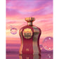 Luxury perfume bottle labeled 'Highness IX' with gold accents against a sunset background