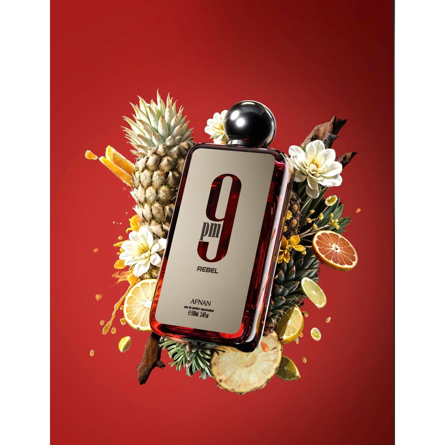 Afnan 9pm Rebel perfume bottle with pineapple, citrus fruits, and flowers on a red background.
