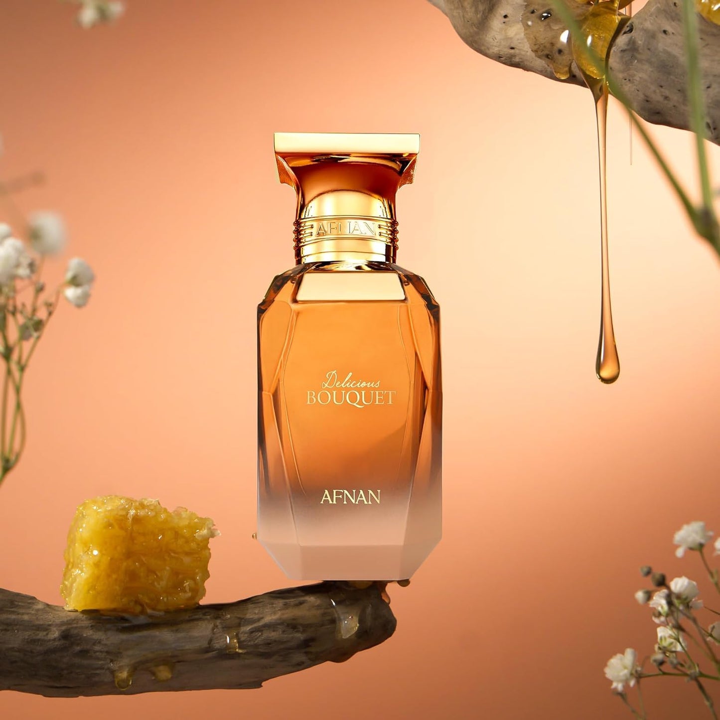 Afnan Delicious Bouquet perfume bottle with honeycomb, honey drips, and flowers on a golden background