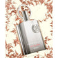 Luxury Supremacy perfume by AFNAN, sleek silver bottle with rose leaf backdrop, long-lasting oud fragrance