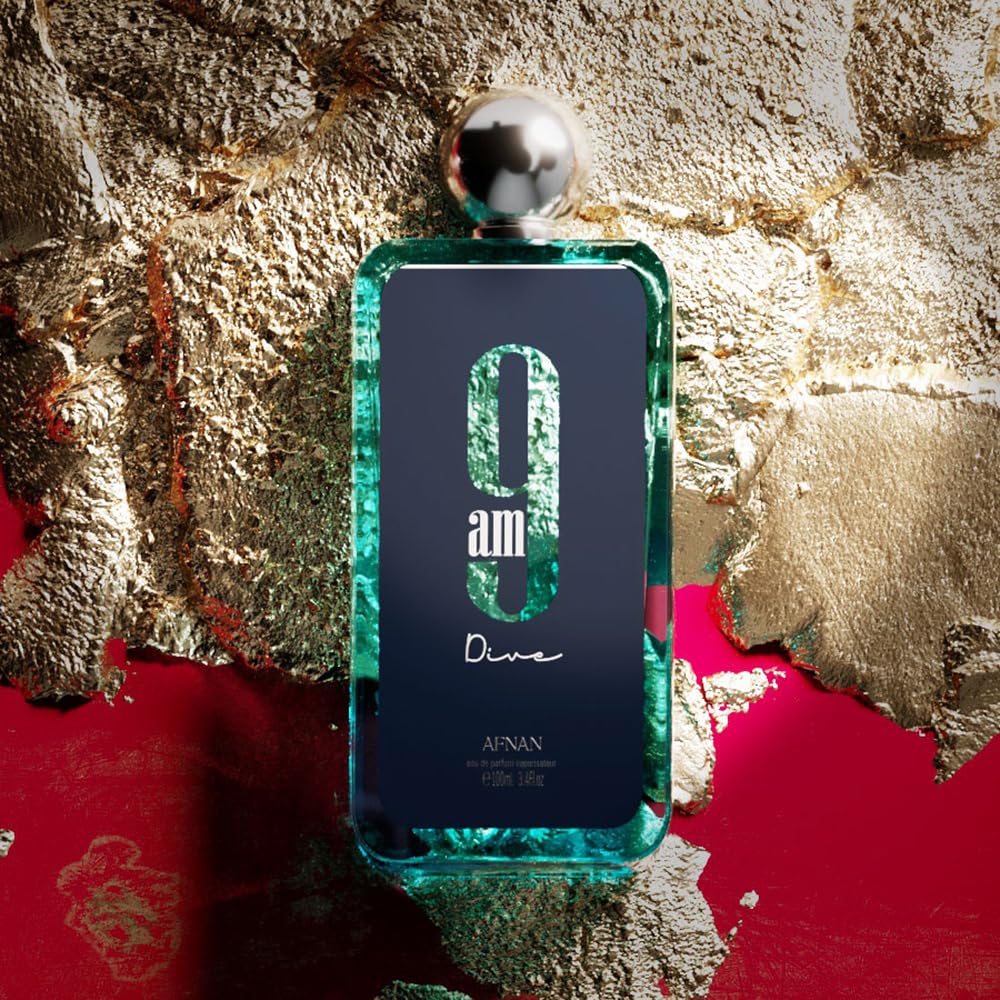 Afnan 9am Dive perfume bottle with blue-green glass and metallic cap on gold textured background