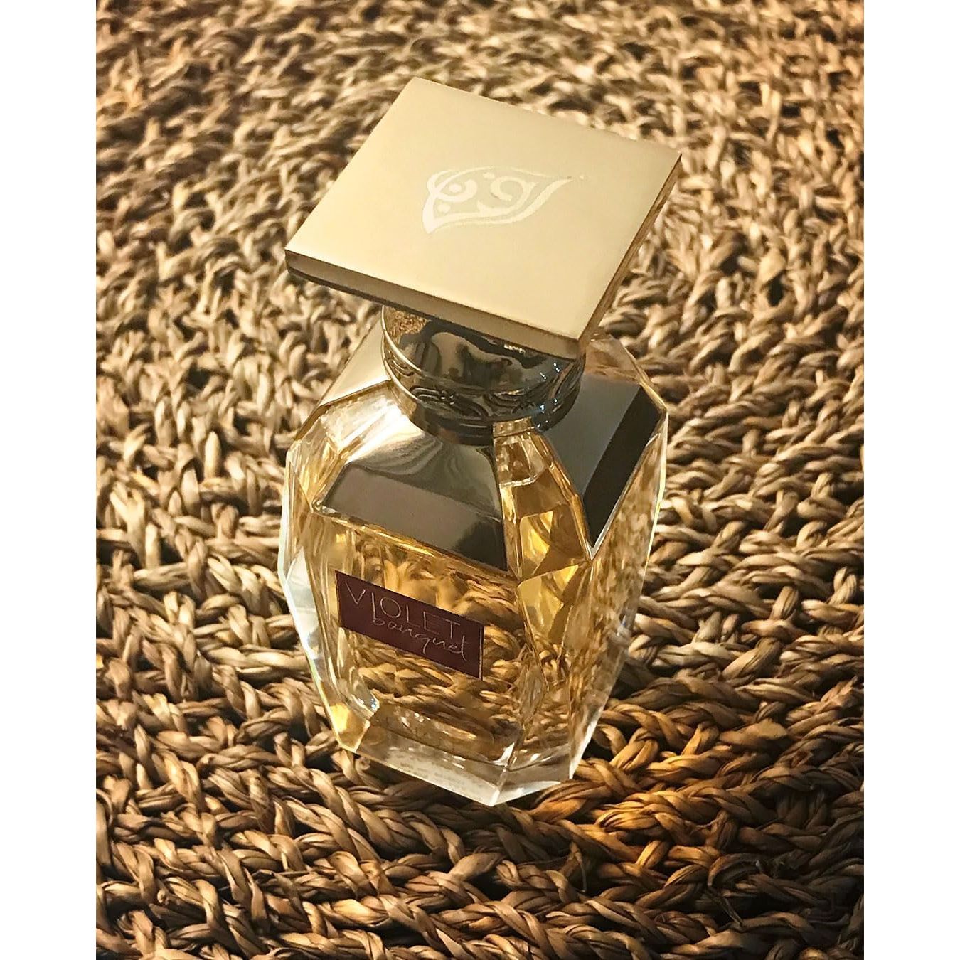 Violet Bouquet luxury perfume bottle with gold cap on woven texture, elegant designer fragrance