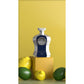 Luxury perfume bottle with silver, blue accents and VI label, styled with lemons and limes.