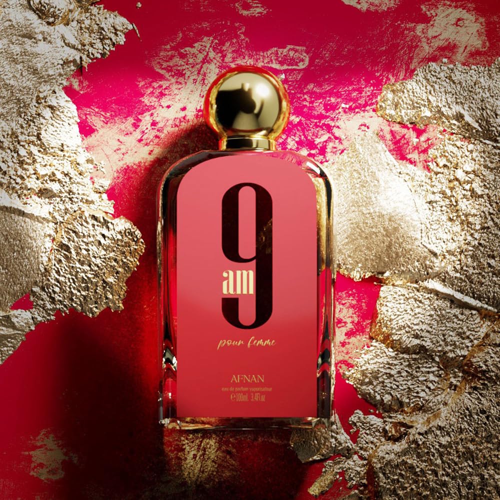 Afnan 9am pour femme perfume bottle with gold cap on red and gold textured background
