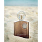 Luxury Supremacy perfume bottle on sandy beach, featuring elegant design and Arabic-inspired fragrance.