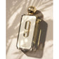 Afnan 9am perfume bottle with gold cap on sunlit textured surface, luxury fragrance