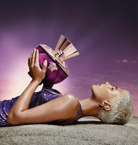 Woman holding luxury purple perfume bottle, elegant Arabic fragrance with gold accents, long-lasting scent