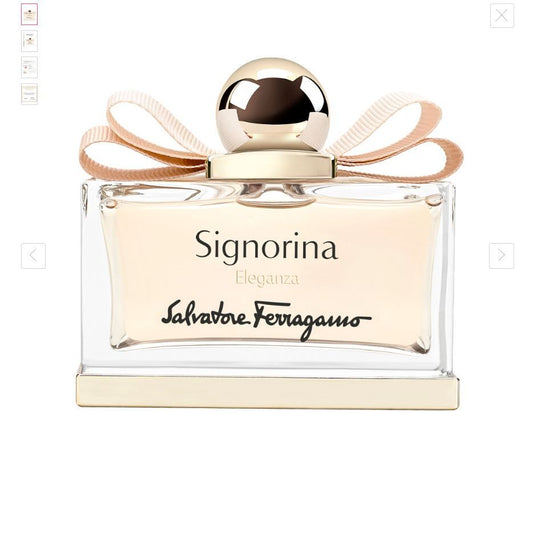 Clear glass bottle of Signorina Eleganza Eau de Parfum with gold cap and pink ribbon detail